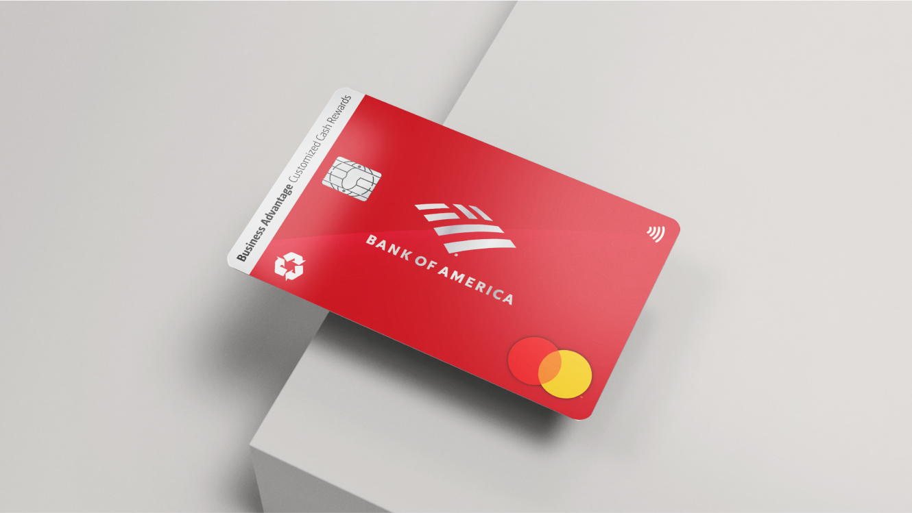 A Bank of America® Business Advantage Customized Cash Rewards Mastercard® credit card on the edge of a grey table.