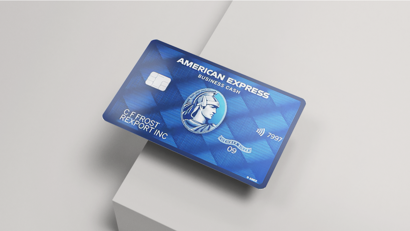 The American Express Blue Business Cash Card hanging on the edge of a grey table.