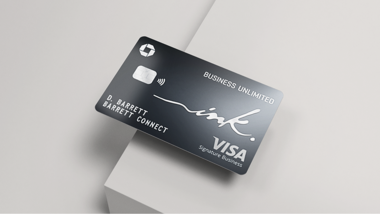 A Ink Business Unlimited Credit Card on the edge of a grey table. 