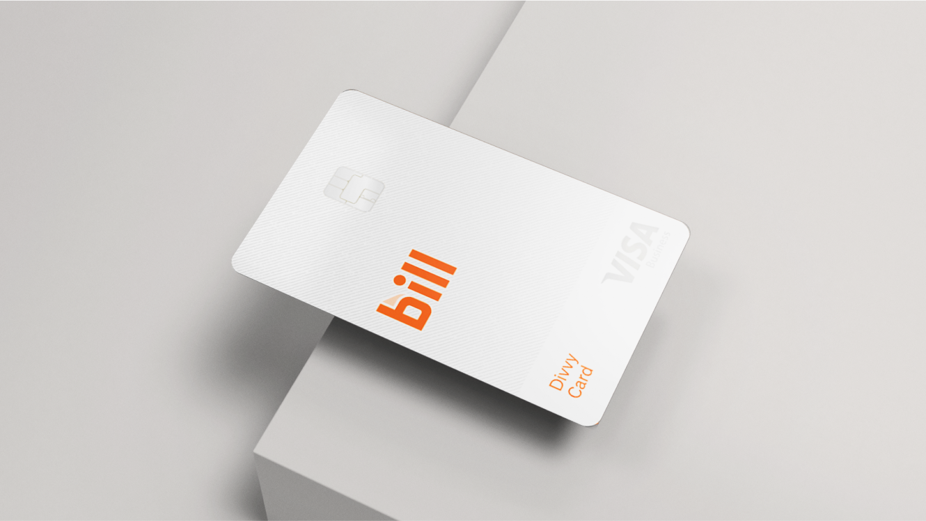 A Bill Divvy Corporate Card on the edge of a grey table.