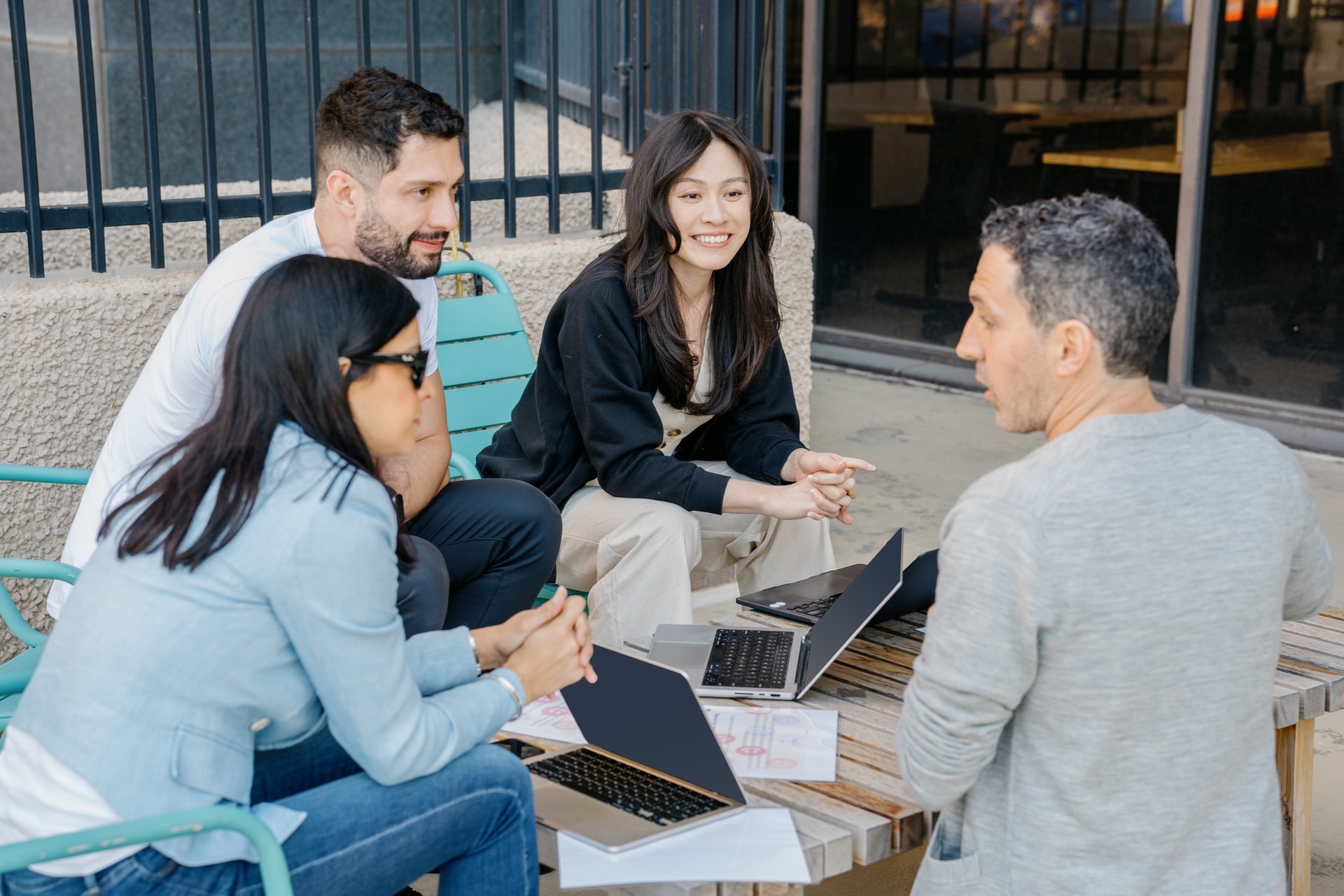 A group of people talking around a table